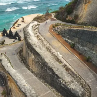 Aerial view of Melasti Beach Bali with dramatic limestone cliffs and crystal clear ocean